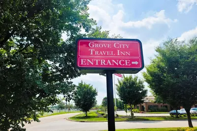 a sign for a groove city travel inn entrance at Grove City Travel Inn South Columbus in Grove City
