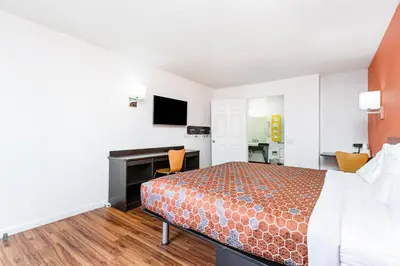 a hotel room with a bed and a desk at Relax Inn by OYO Columbus OH I 70 in Columbus