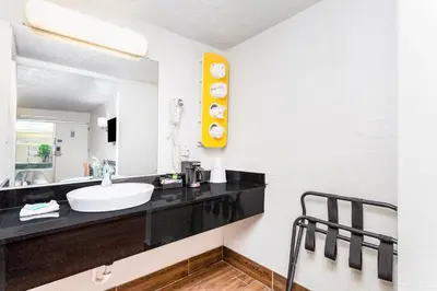 a bathroom with a sink and a mirror at Relax Inn by OYO Columbus OH I 70 in Columbus