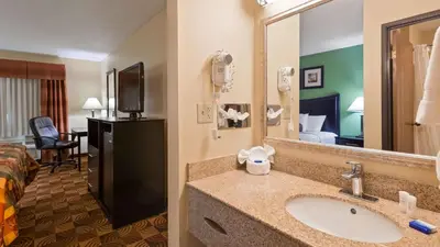 a hotel room with a bathroom with a sink and a bed at Best Western Canal Winchester Inn-Columbus South East in Canal Winchester