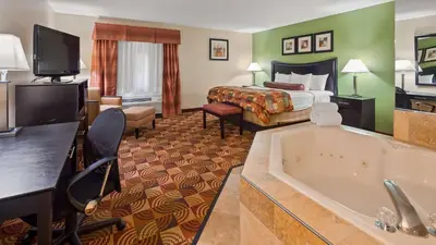 a hotel room with a tub and a bed at Best Western Canal Winchester Inn-Columbus South East in Canal Winchester