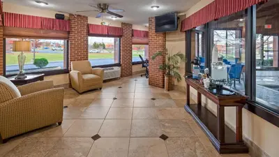 a lobby with a waiting area with chairs and a television at Best Western Canal Winchester Inn-Columbus South East in Canal Winchester