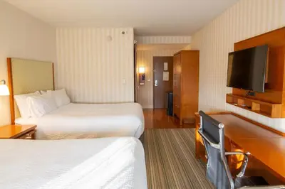 a hotel room with two beds and a flat screen tv at Holiday Inn Express Columbus Airport Easton in Columbus