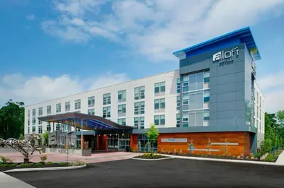 a hotel with a sign on the front of a building at Aloft Columbus Westerville in Westerville