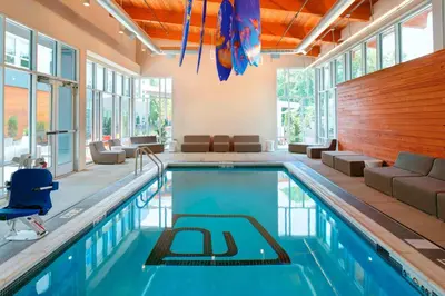 a swimming pool in a house with a room with windows at Aloft Columbus Westerville in Westerville