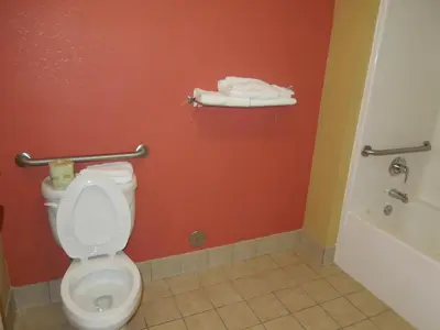 a bathroom with a toilet and a bath tub at Kozy Inn Columbus in Columbus