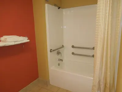 a bathroom with a tub and a shower curtain at Kozy Inn Columbus in Columbus