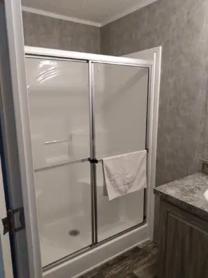 a shower with a glass door in a bathroom at Lake Point Motel in Marblehead