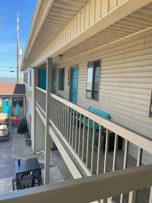 a balcony of a house with a table and chairs at Lake Point Motel in Marblehead