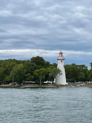 a lighthouse on the shore of a body of water at Lake Point Motel in Marblehead