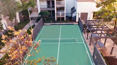 a tennis court in the backyard of a house at Hawthorn Extended Stay by Wyndham Columbus in Columbus
