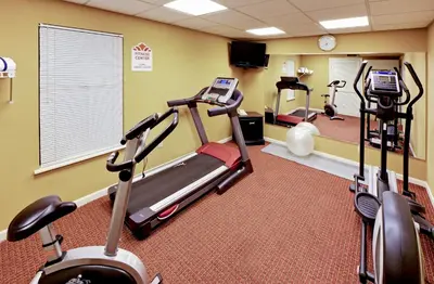 a gym with two tread machines in a room at Hawthorn Extended Stay by Wyndham Columbus in Columbus