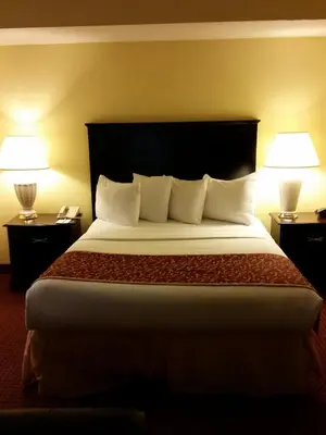 a hotel room with a large bed with two lamps at Hawthorn Extended Stay by Wyndham Columbus in Columbus