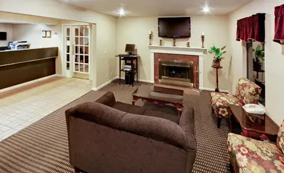 a living room with a couch and a fireplace at Hawthorn Extended Stay by Wyndham Columbus in Columbus