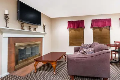 a living room with a fireplace and a tv at Hawthorn Extended Stay by Wyndham Columbus in Columbus