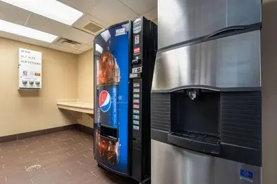 a drink vending machine next to a refrigerator at Holiday Inn Express & Suites Hebron - Cincinnati Airport by IHG in Hebron