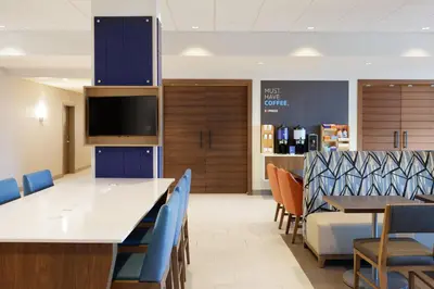 a dining room with a large table and chairs at Holiday Inn Express & Suites Hebron - Cincinnati Airport by IHG in Hebron