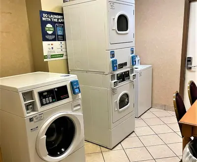 a washing machine and a dryer in a room at Baymont by Wyndham Greenfield in Greenfield