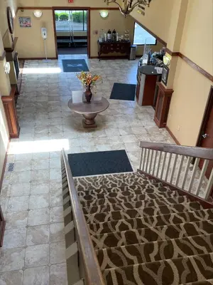 a view of a lobby with a couch and a table at Baymont by Wyndham Greenfield in Greenfield