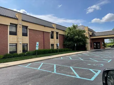 a parking lot in front of a building at Baymont by Wyndham Greenfield in Greenfield