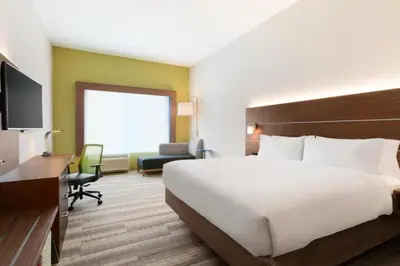 a hotel room with a large bed and a desk at Holiday Inn Express & Suites - Cincinnati NE - Red Bank Road by IHG in Cincinnati