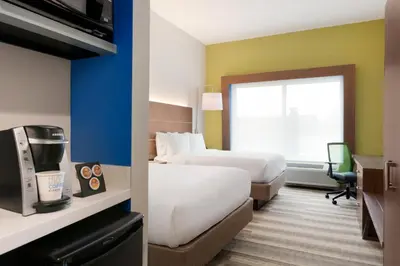 a hotel room with two beds and a desk at Holiday Inn Express & Suites - Cincinnati NE - Red Bank Road by IHG in Cincinnati
