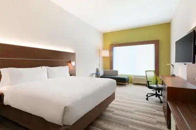 a hotel room with a large bed and a desk at Holiday Inn Express & Suites - Cincinnati NE - Red Bank Road by IHG in Cincinnati