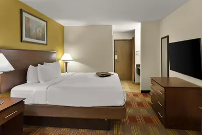 a hotel room with a bed and a flat screen tv at Best Western Lakewood Inn in Hebron