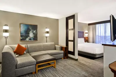 a hotel room with a couch and a bed at Hyatt Place Columbus Worthington in Worthington