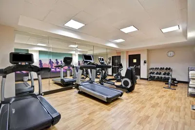 a gym with treadmills and ellipticals in a room at Hyatt Place Columbus Worthington in Worthington