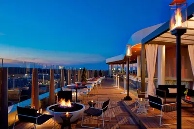a balcony with tables and chairs on a building at AC Hotel Columbus Dublin in Dublin