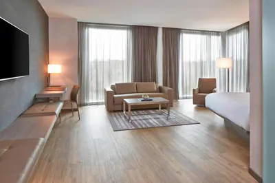 a hotel room with a couch and a bed and a living room at AC Hotel Columbus Dublin in Dublin