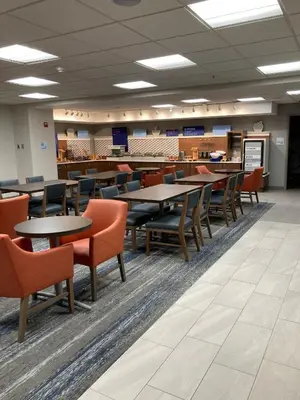 a dining room with tables and chairs in a building at Holiday Inn Express - Akron NW - Fairlawn by IHG in Akron