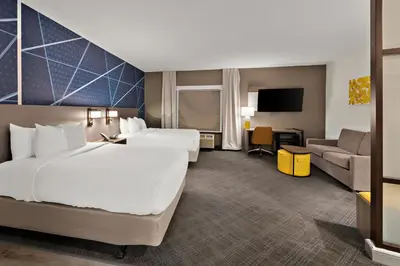 a hotel room with two beds and a couch at Comfort Suites Columbus East Broad in Columbus