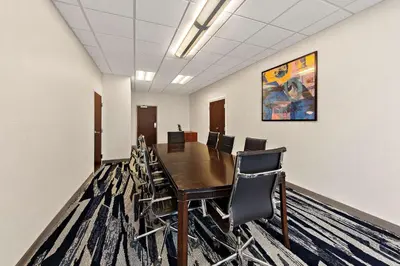 a conference room with a wooden table and chairs at Comfort Suites Columbus East Broad in Columbus