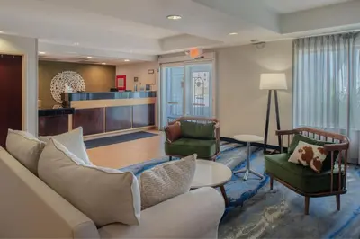 a living room with a couch and two chairs at Fairfield Inn & Suites by Marriott Dayton Troy in Troy