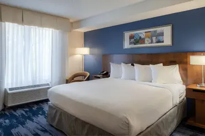 a hotel room with a large bed and a window at Fairfield Inn & Suites by Marriott Dayton Troy in Troy