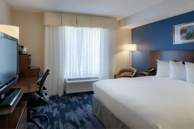 a hotel room with a large bed and a window at Fairfield Inn & Suites by Marriott Dayton Troy in Troy