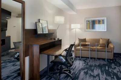 a hotel room with a desk and a chair at Fairfield Inn & Suites by Marriott Dayton Troy in Troy
