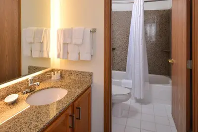 a bathroom with a sink and a toilet and a shower at Residence Inn by Marriott Dayton Troy in Troy