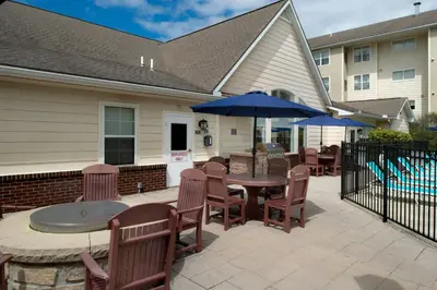 a patio with tables and chairs and umbrellas at Residence Inn by Marriott Dayton Troy in Troy