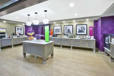 a store with purple walls and tables in a room at Hampton Inn & Suites Oakwood Village-Cleveland in Oakwood