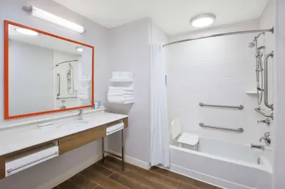 a bathroom with a tub and a sink and a shower at Hampton Inn & Suites Oakwood Village-Cleveland in Oakwood