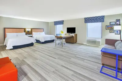 a hotel room with two beds and a flat screen tv at Hampton Inn & Suites Oakwood Village-Cleveland in Oakwood