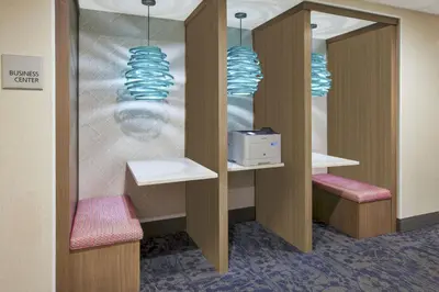 a waiting room with two chairs and two mirrors at Hampton Inn & Suites Oakwood Village-Cleveland in Oakwood