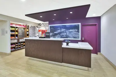 a store lobby with a counter and a purple wall at Hampton Inn & Suites Oakwood Village-Cleveland in Oakwood