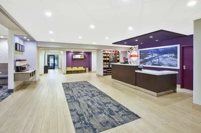 a lobby of a store with a counter and a rug at Hampton Inn & Suites Oakwood Village-Cleveland in Oakwood