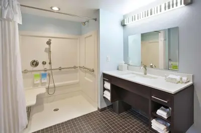 a bathroom with a sink and a shower and a mirror at Home2 Suites By Hilton Pittsburgh Area Beaver Valley in Monaca