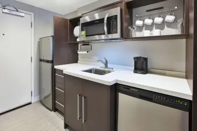a small kitchen with a sink and a microwave at Home2 Suites By Hilton Pittsburgh Area Beaver Valley in Monaca