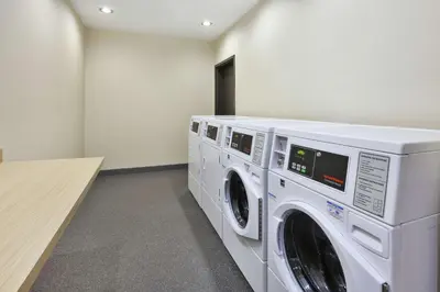 a laundry room with two washing machines in it at Home2 Suites By Hilton Pittsburgh Area Beaver Valley in Monaca